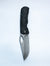 Dixon folding pocket knife with a rock textured black handle shown open against a white background